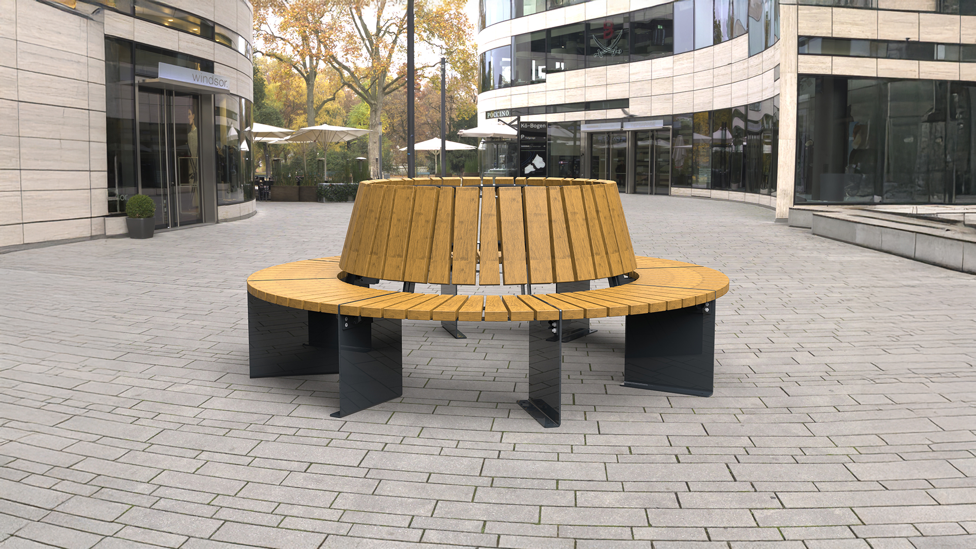 Moderne runde Holzsitzbank mit Stahlfüßen auf einem gepflasterten Platz in urbaner Umgebung.